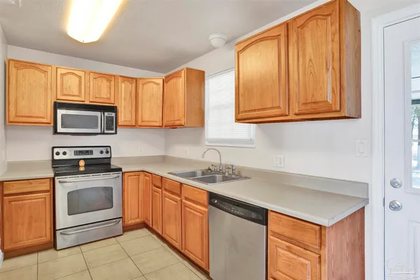 a kitchen with stainless steel appliances granite countertop a sink stove and microwave
