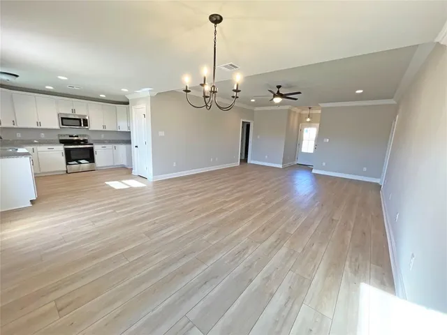 a view of a kitchen with stove and cabinets