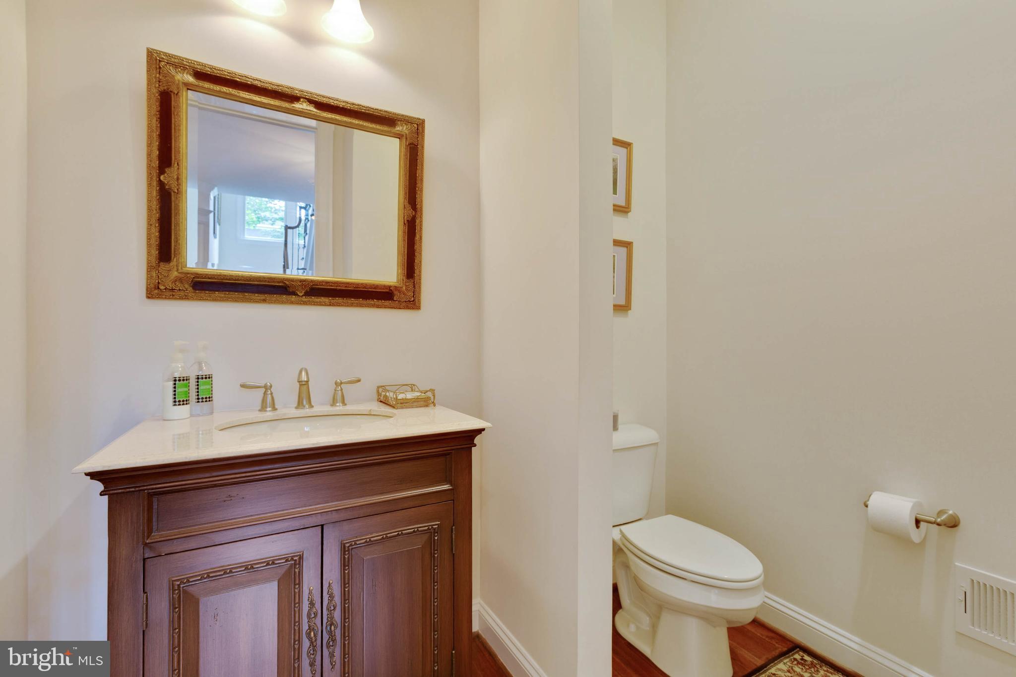 3003 Weber Place Oakton, VA 22124 - Photo 24 of 63 a bathroom with a toilet sink and mirror