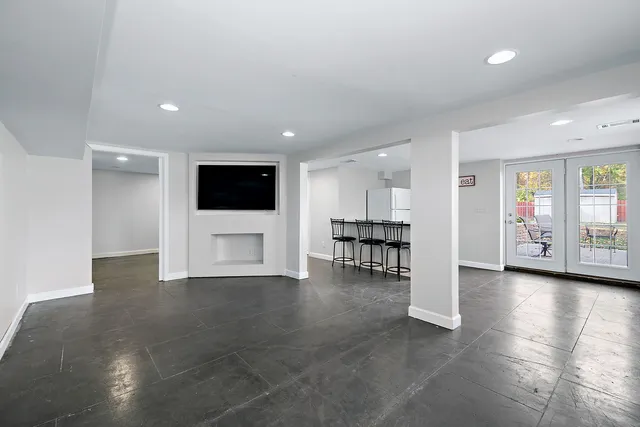 a view of a livingroom with furniture and an empty room