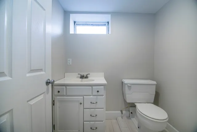 a white toilet sitting next to a bathroom sink