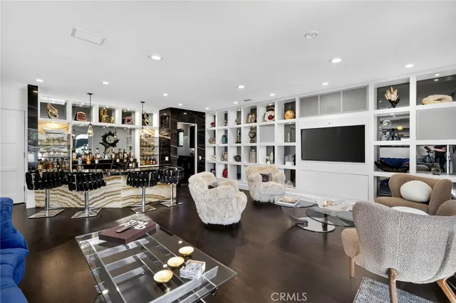 a view of swimming pool with seating area and furniture in front of it