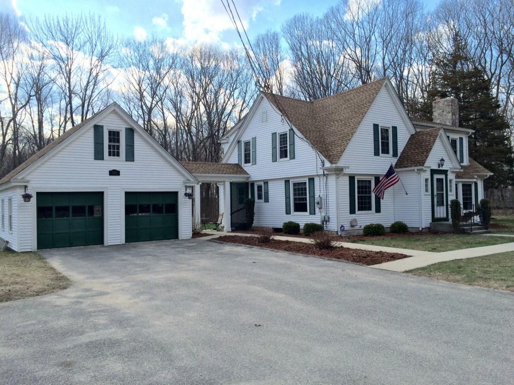 184 Orchard Hill Road Pomfret, CT 06259 - Photo 1 of 1 a front view of a house with a yard and garage