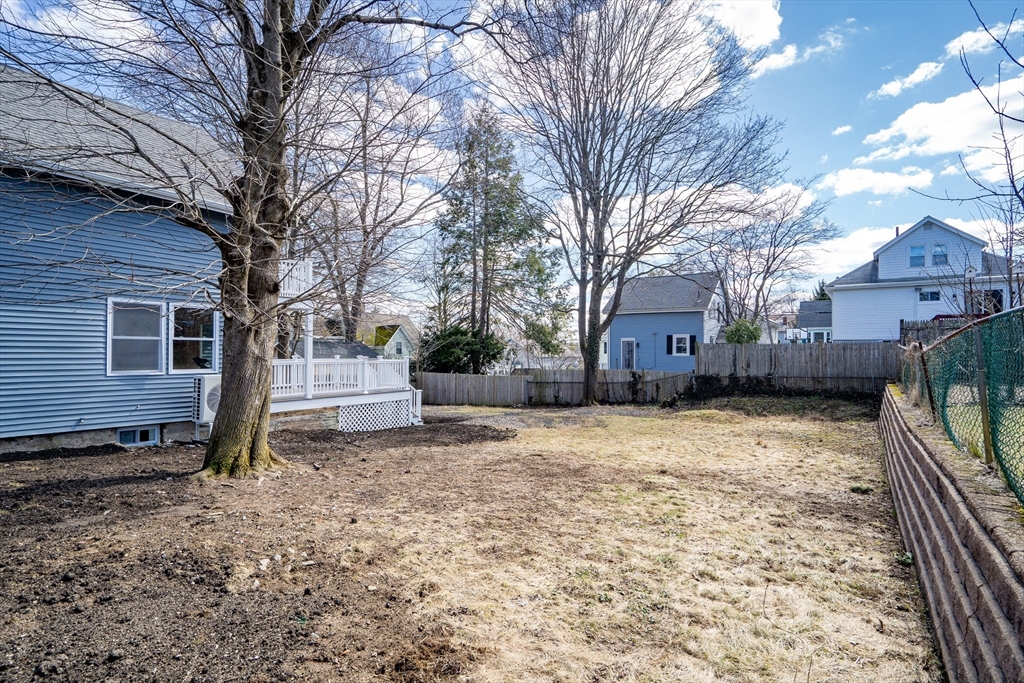 56 Riverview Street Dedham, MA 02026 - Photo 26 of 29 a front view of a house with a yard and garage