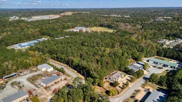 an aerial view of a residential houses with city view