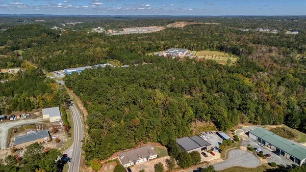 an aerial view of a residential houses with city view