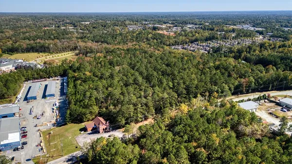 an aerial view of a house with a yard