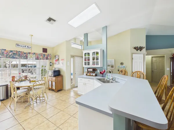 a very nice looking living room with furniture and kitchen view