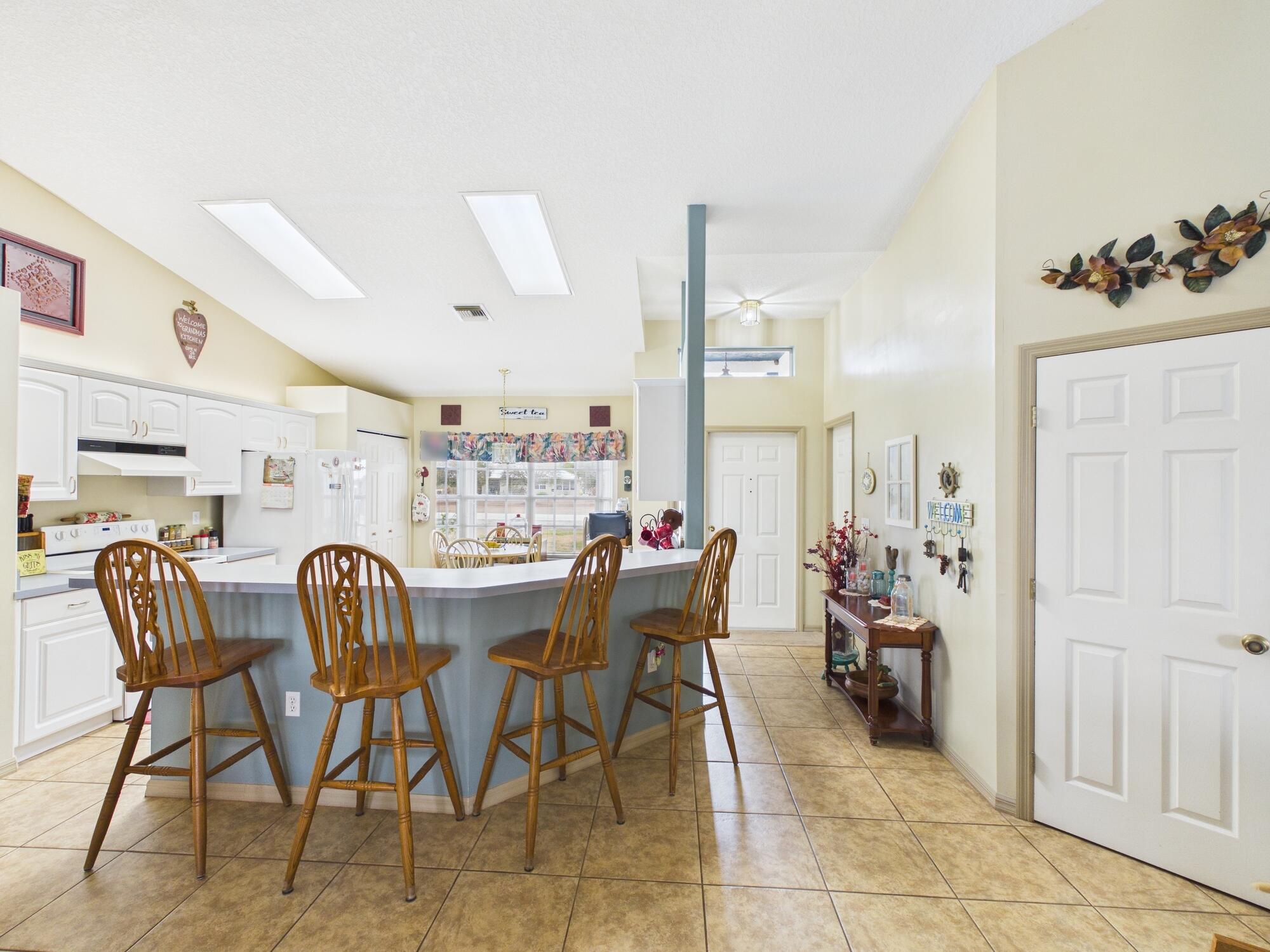 8525 Southwest 9th Street Okeechobee, FL 34974 - Photo 19 of 67 a dining room with furniture and wooden floor