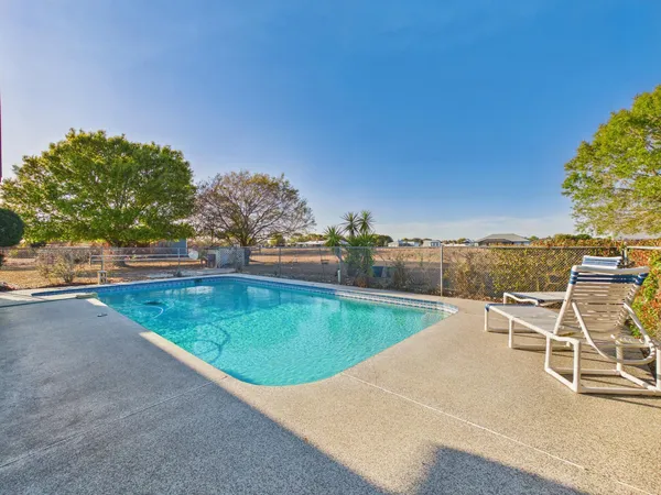 a view of a swimming pool with a lounge chair