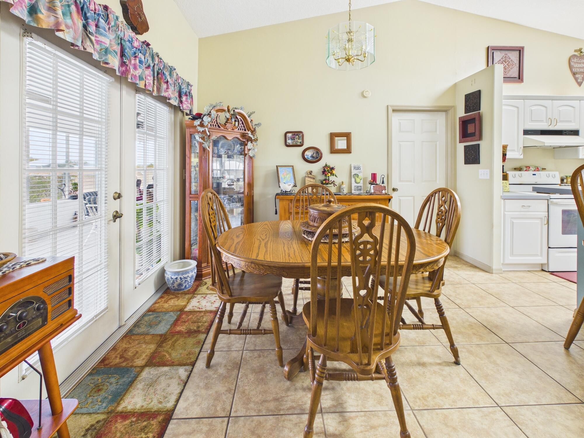 8525 Southwest 9th Street Okeechobee, FL 34974 - Photo 22 of 67 a view of a dining room with furniture and chandelier