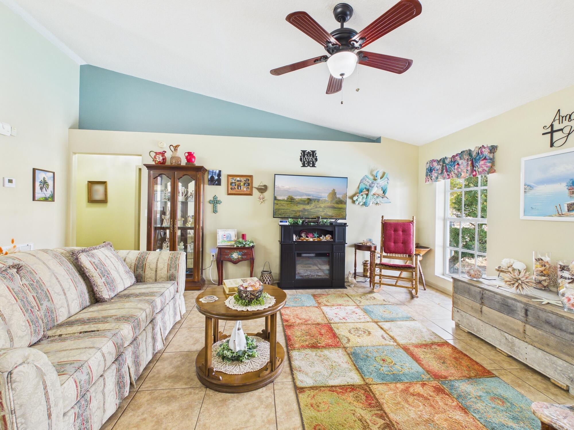 8525 Southwest 9th Street Okeechobee, FL 34974 - Photo 25 of 67 a living room with furniture and a fireplace
