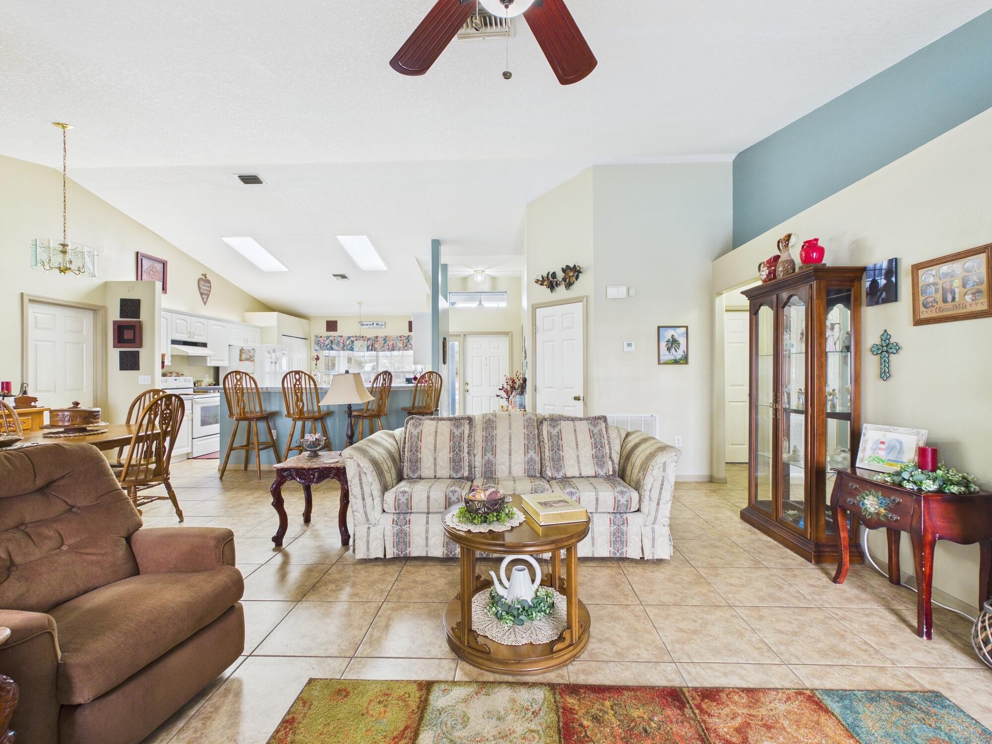8525 Southwest 9th Street Okeechobee, FL 34974 - Photo 27 of 67 a living room with furniture and a chandelier