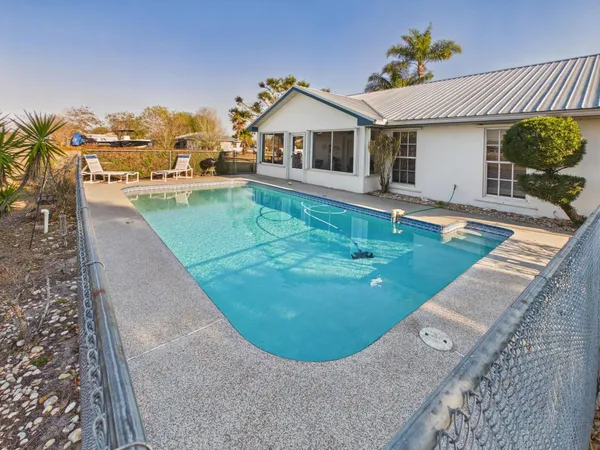 swimming pool view with a garden space