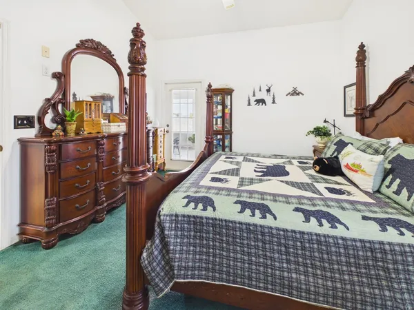 a bedroom with a bed and a chandelier