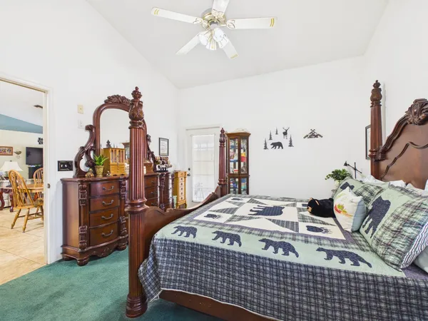 a bedroom with a bed and dresser
