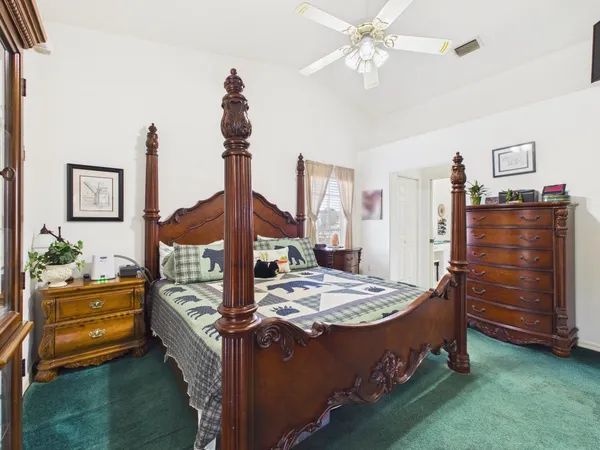 a bathroom with a granite countertop shower and a toilet