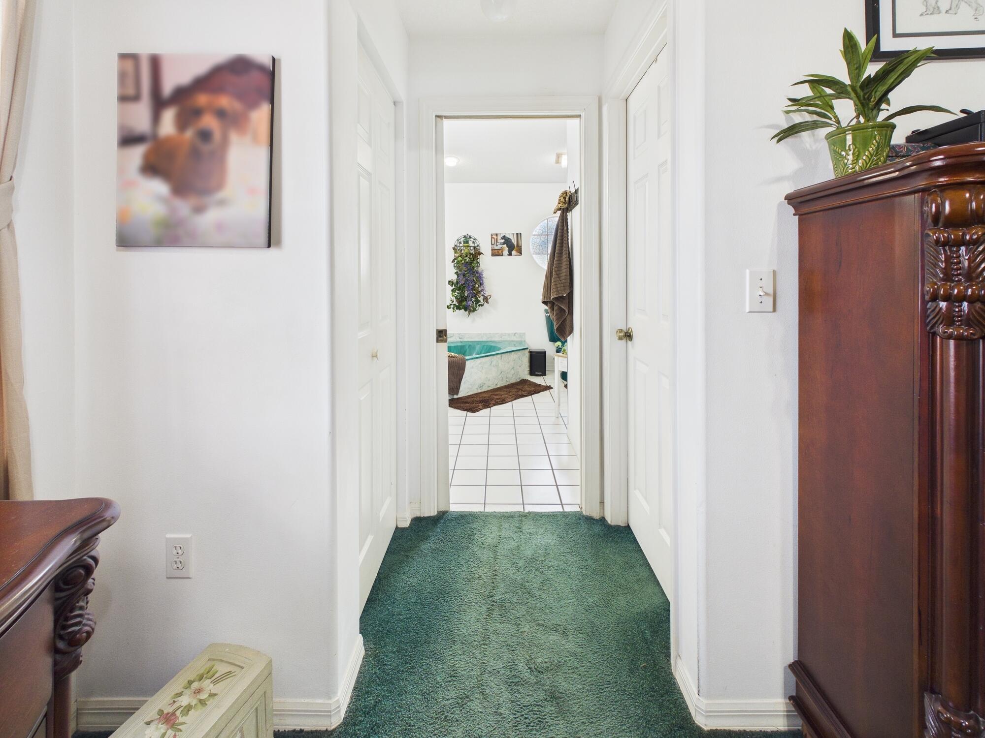 8525 Southwest 9th Street Okeechobee, FL 34974 - Photo 38 of 67 a view of a hallway with paintings on the wall