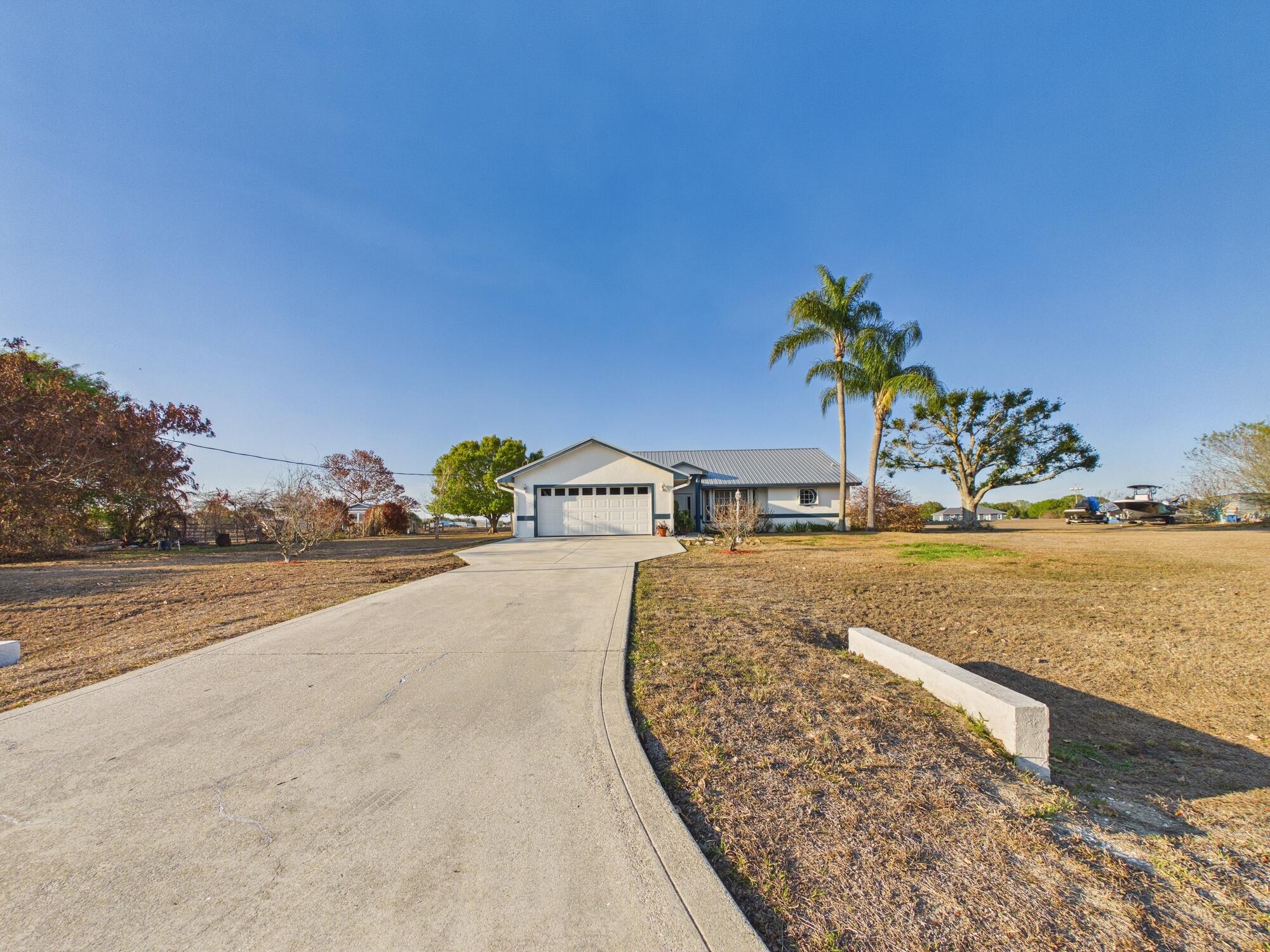 8525 Southwest 9th Street Okeechobee, FL 34974 - Photo 4 of 67 a view of a house with a yard