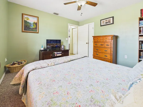 a living room with furniture and a dining table with wooden floor