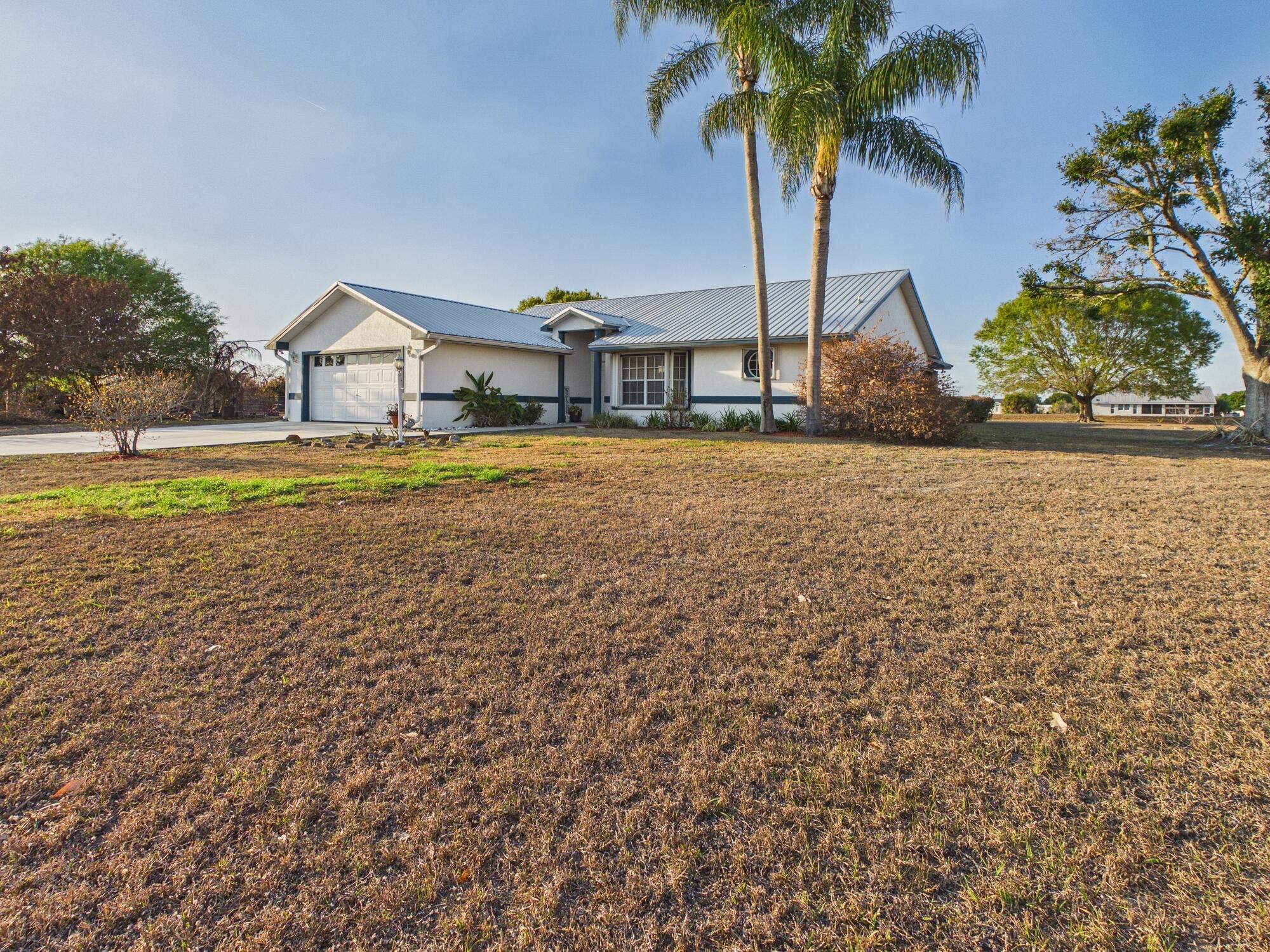 8525 Southwest 9th Street Okeechobee, FL 34974 - Photo 5 of 67 a front view of a house with garden