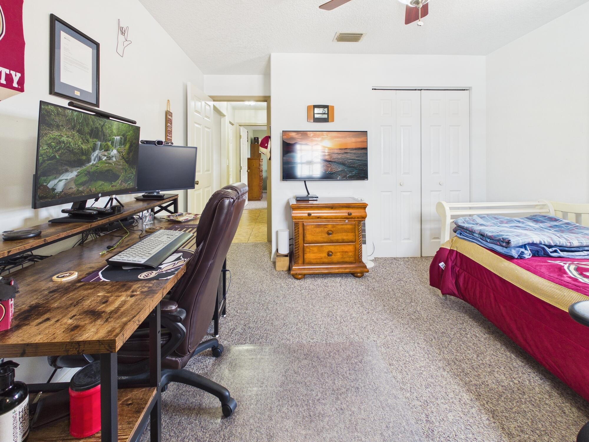 8525 Southwest 9th Street Okeechobee, FL 34974 - Photo 55 of 67 a room with furniture and flat screen tv