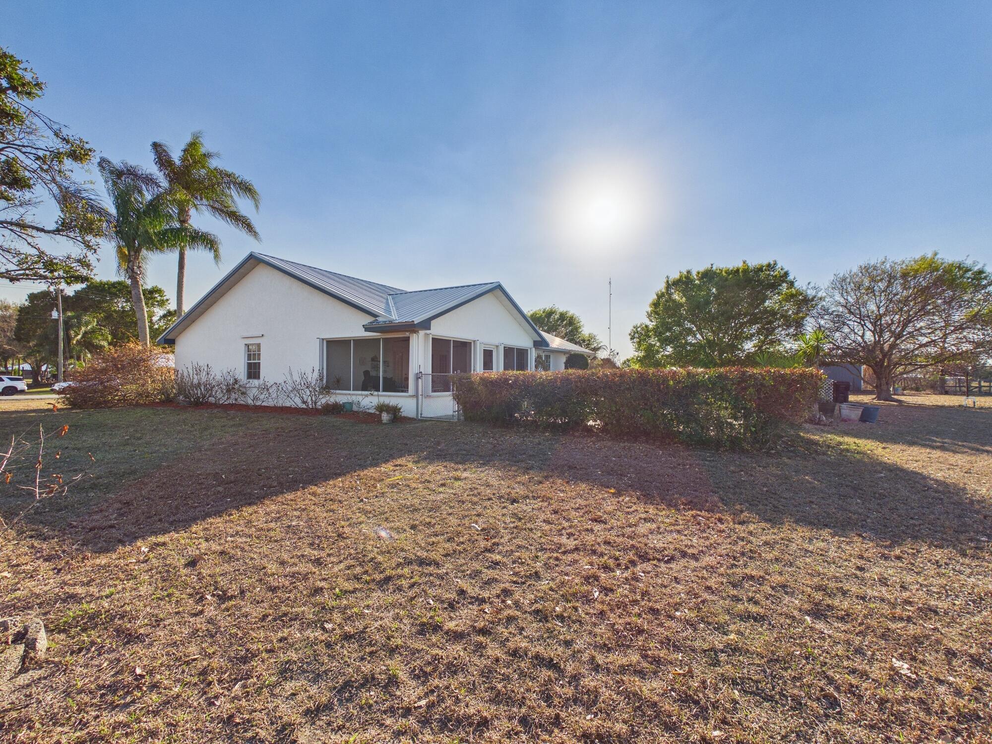 8525 Southwest 9th Street Okeechobee, FL 34974 - Photo 56 of 67 a view of house with a yard and a large parking space