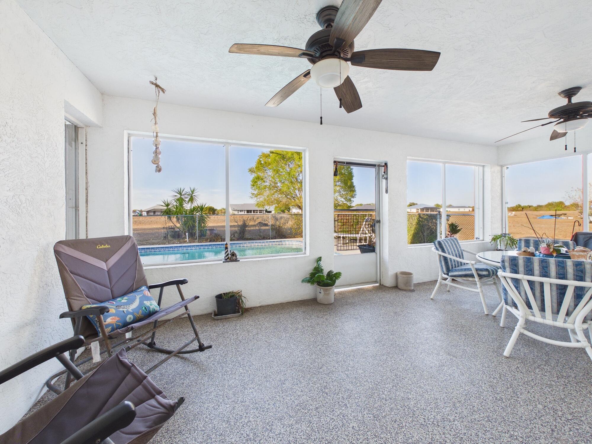 8525 Southwest 9th Street Okeechobee, FL 34974 - Photo 64 of 67 a living room with furniture and a dining table with wooden floor