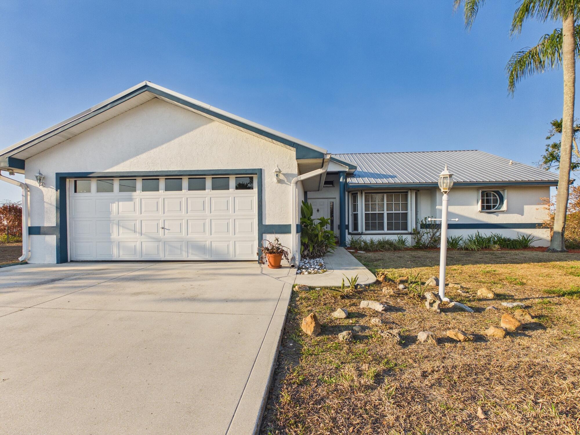 8525 Southwest 9th Street Okeechobee, FL 34974 - Photo 66 of 67 front view of a house with a yard