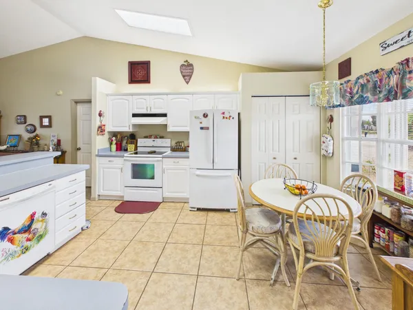a kitchen with stainless steel appliances a refrigerator and a stove top oven