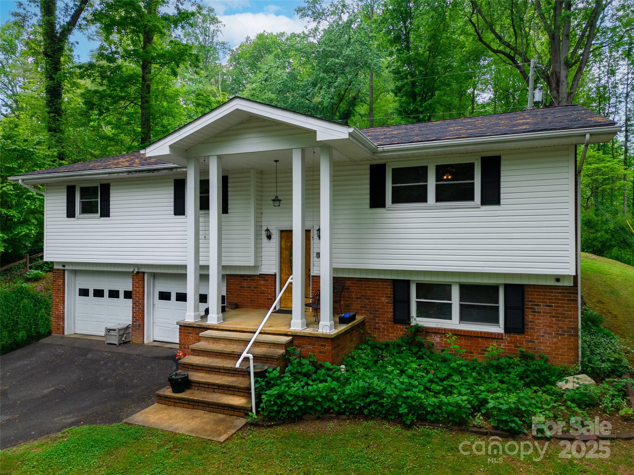 220 Frosty Ridge Road Sylva, NC 28779 - Photo 1 of 32 a view of a house with a yard and large tree