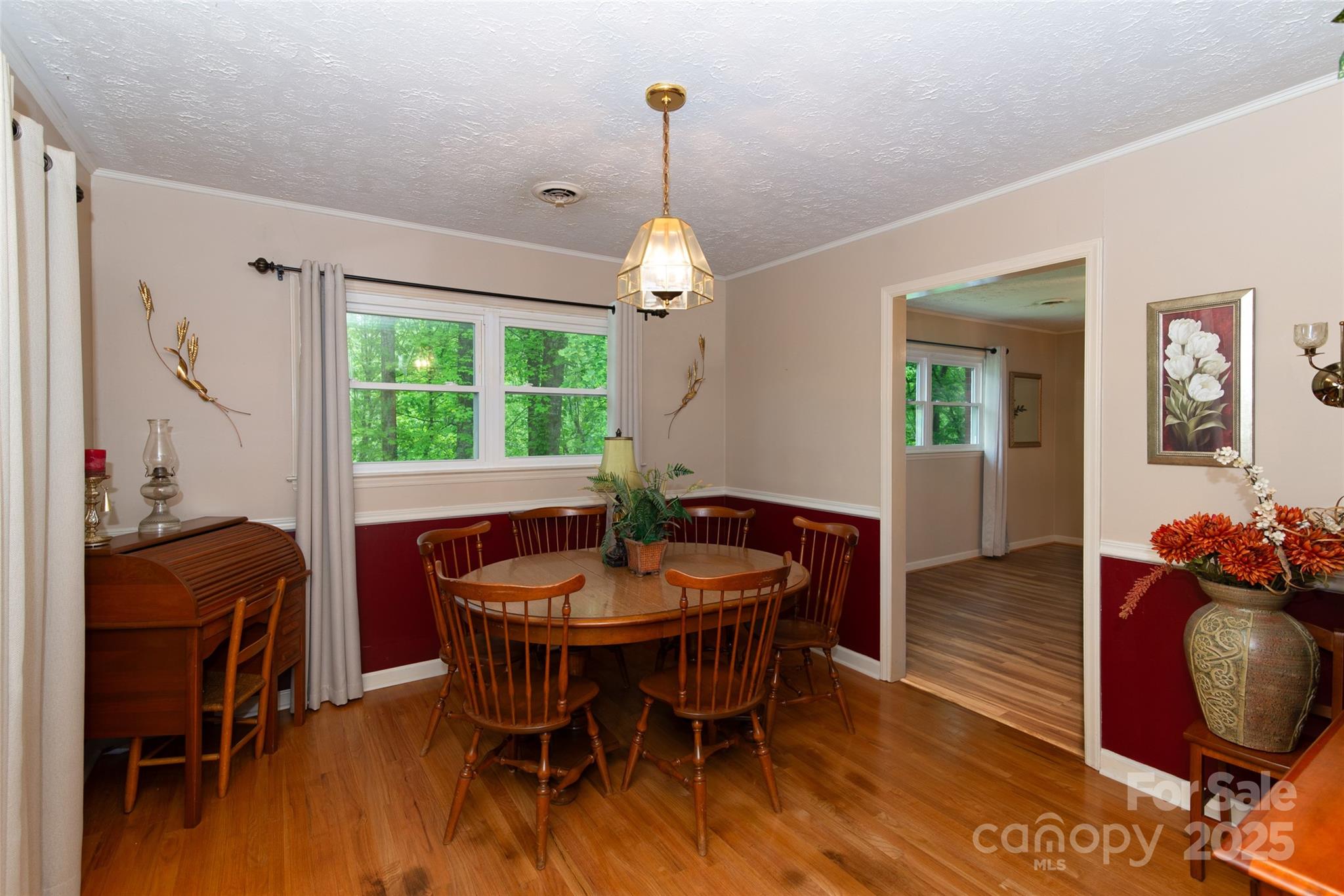 220 Frosty Ridge Road Sylva, NC 28779 - Photo 6 of 32 a dining room with furniture a chandelier and wooden floor