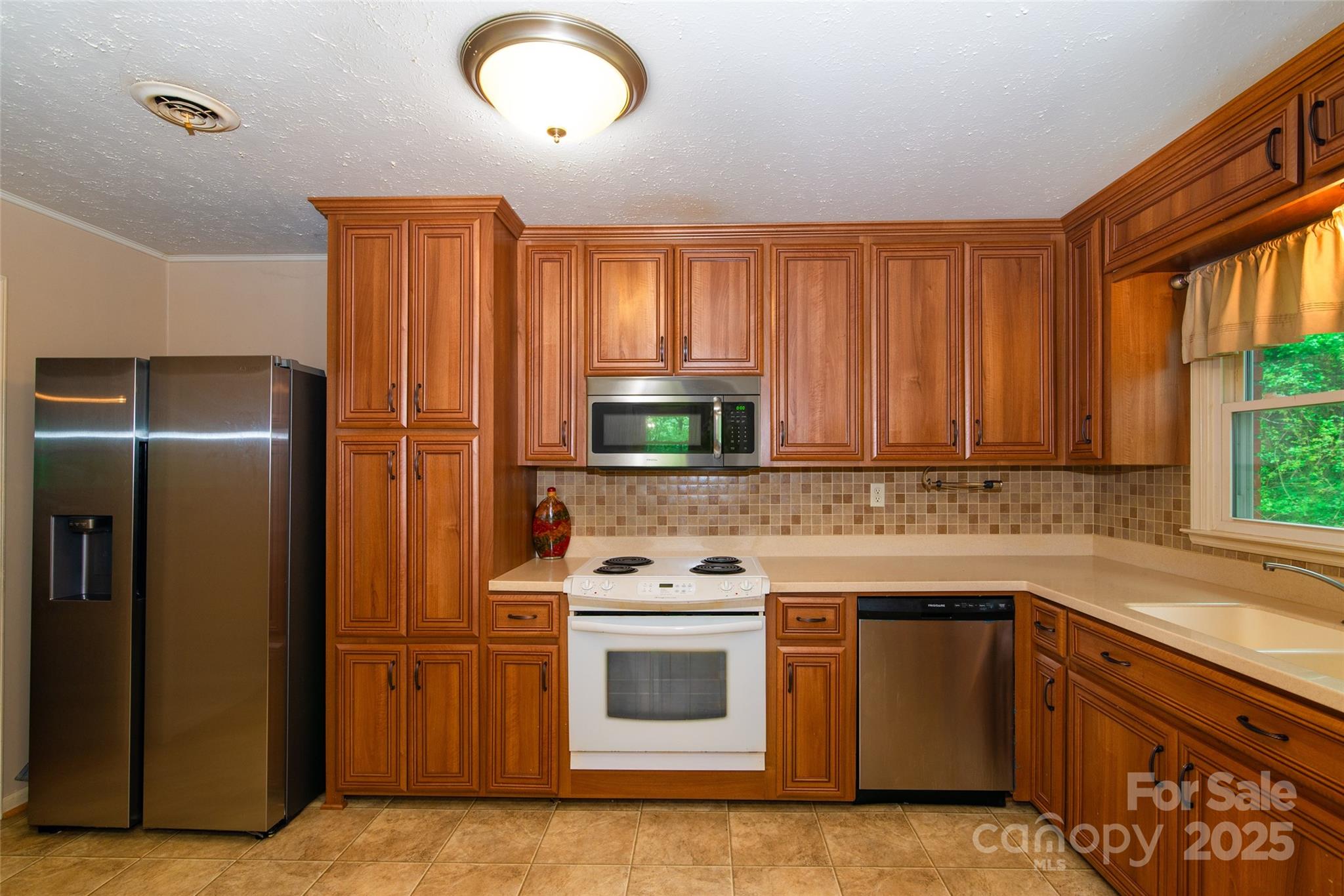 220 Frosty Ridge Road Sylva, NC 28779 - Photo 8 of 32 a kitchen with a stove sink and refrigerator