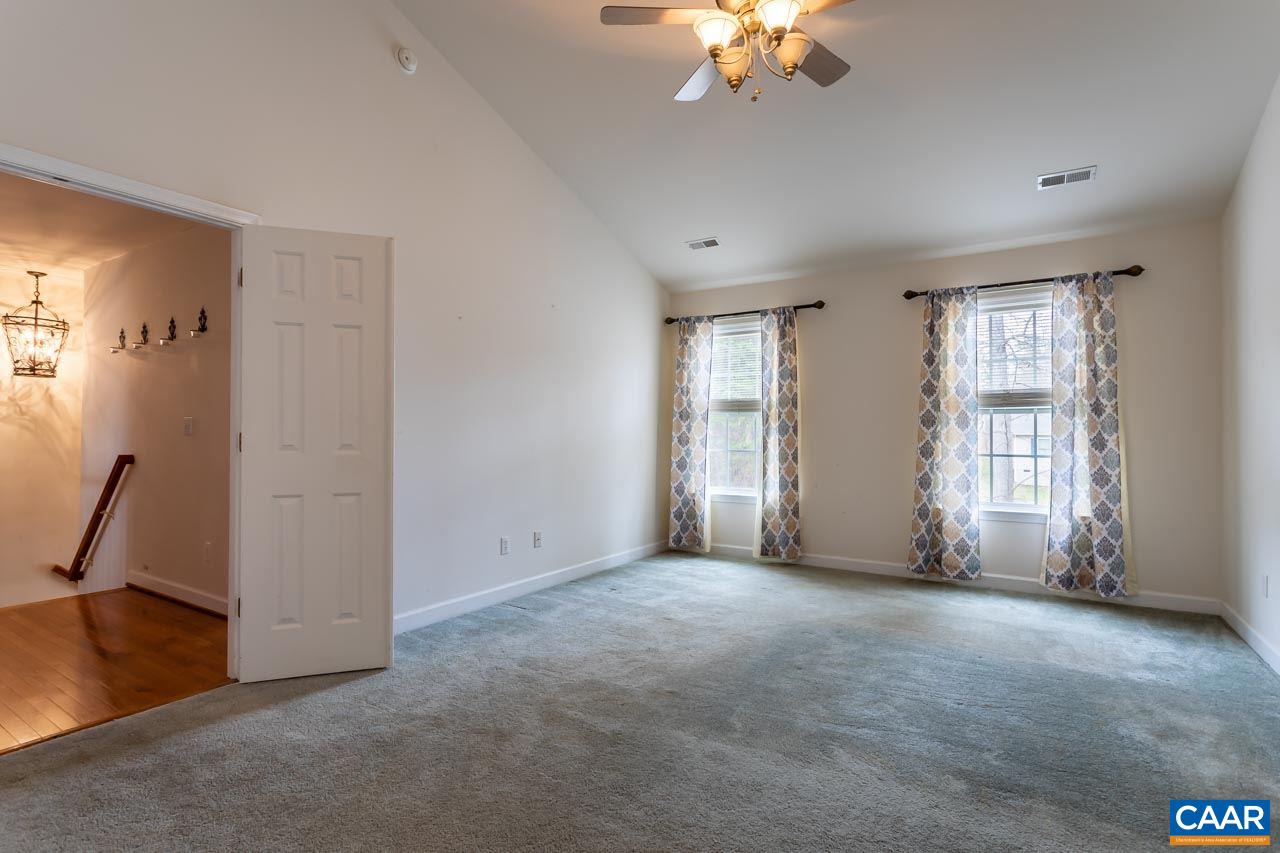 25 Haversack Road Palmyra, VA 22963 - Photo 19 of 42 an empty room with windows and chandelier fan