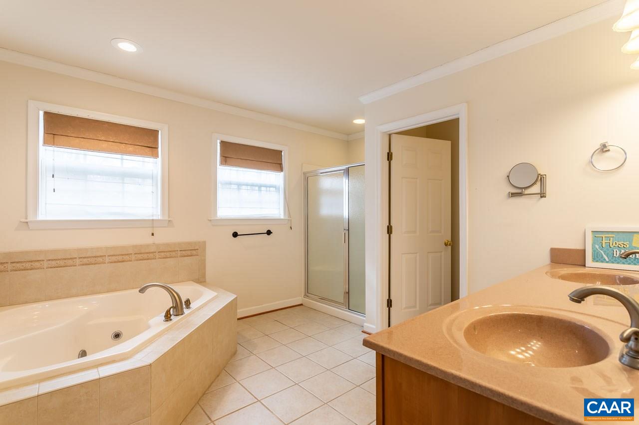 25 Haversack Road Palmyra, VA 22963 - Photo 22 of 42 a bathroom with a tub sink and mirror