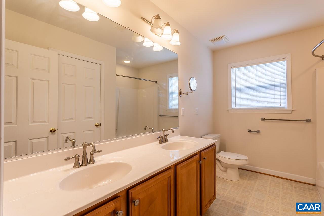 25 Haversack Road Palmyra, VA 22963 - Photo 29 of 42 a bathroom with a sink a toilet a mirror and vanity