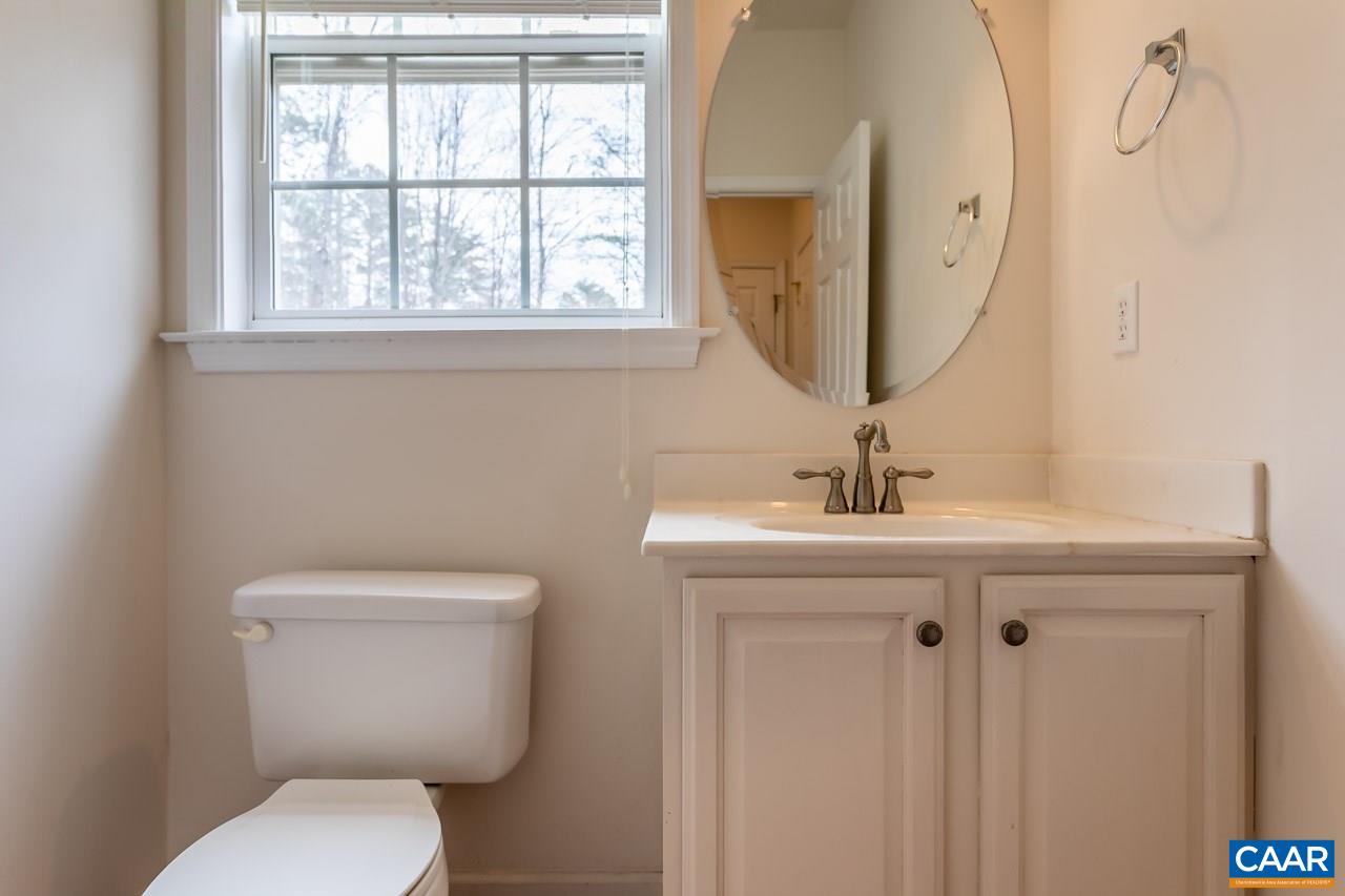 25 Haversack Road Palmyra, VA 22963 - Photo 32 of 42 a bathroom with a toilet a sink and mirror