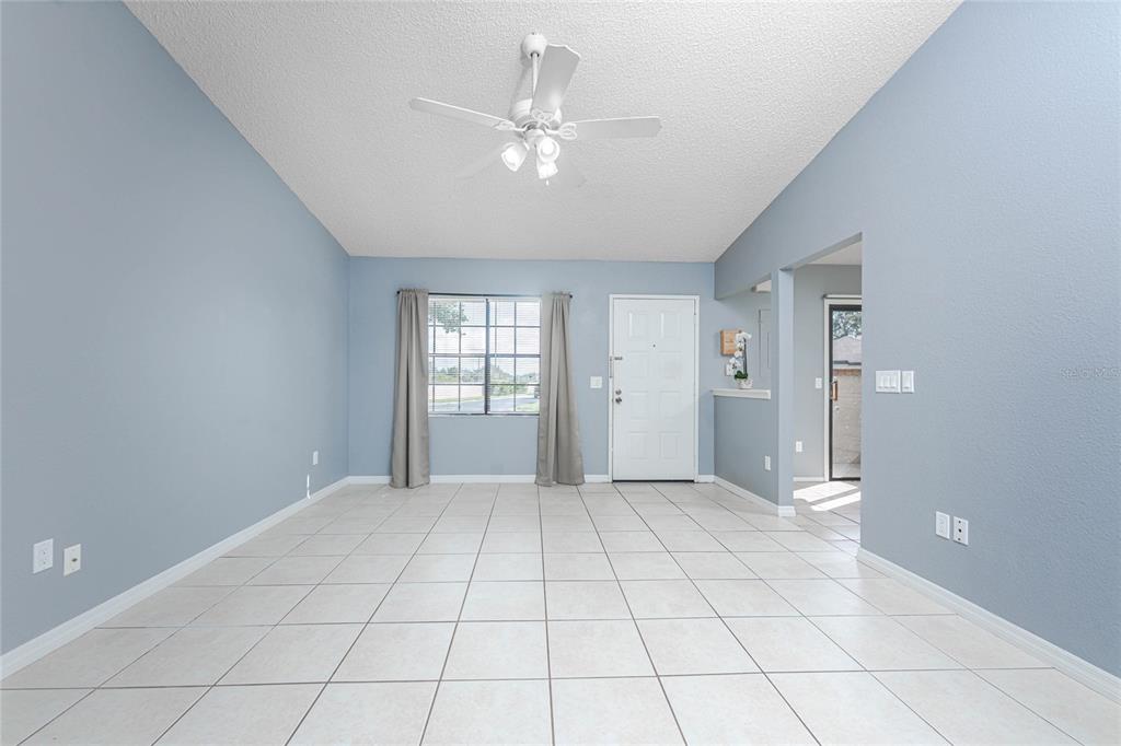 13100 South McCall Road, Unit 191 Port Charlotte, FL 33981 - Photo 11 of 44 a view of an empty room with window and chandelier fan