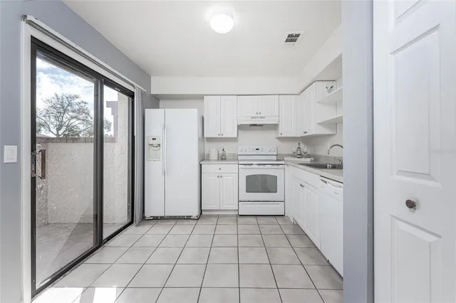 a kitchen with a stove a sink and a refrigerator