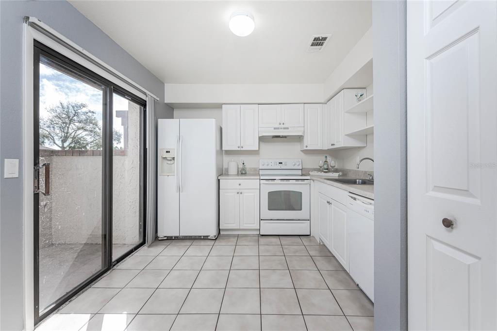 13100 South McCall Road, Unit 191 Port Charlotte, FL 33981 - Photo 14 of 44 a kitchen with a stove a sink and a refrigerator