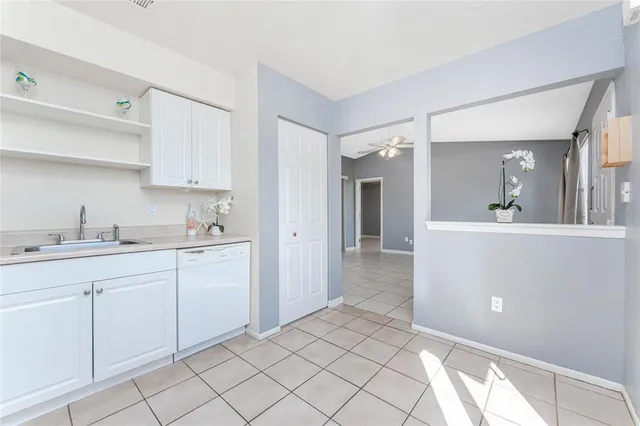 a spacious bathroom with a sink mirror and cabinets