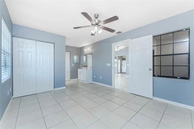 a view of an empty room with a ceiling fan