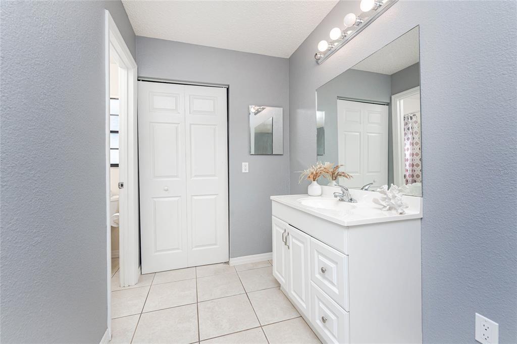 13100 South McCall Road, Unit 191 Port Charlotte, FL 33981 - Photo 21 of 44 a bathroom with a sink a mirror and a vanity