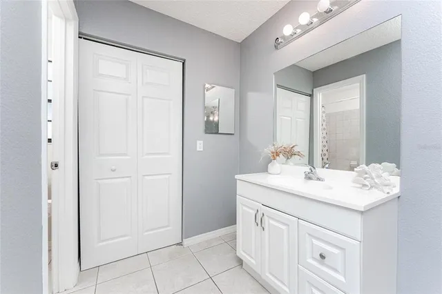 a bathroom with a sink vanity and mirror