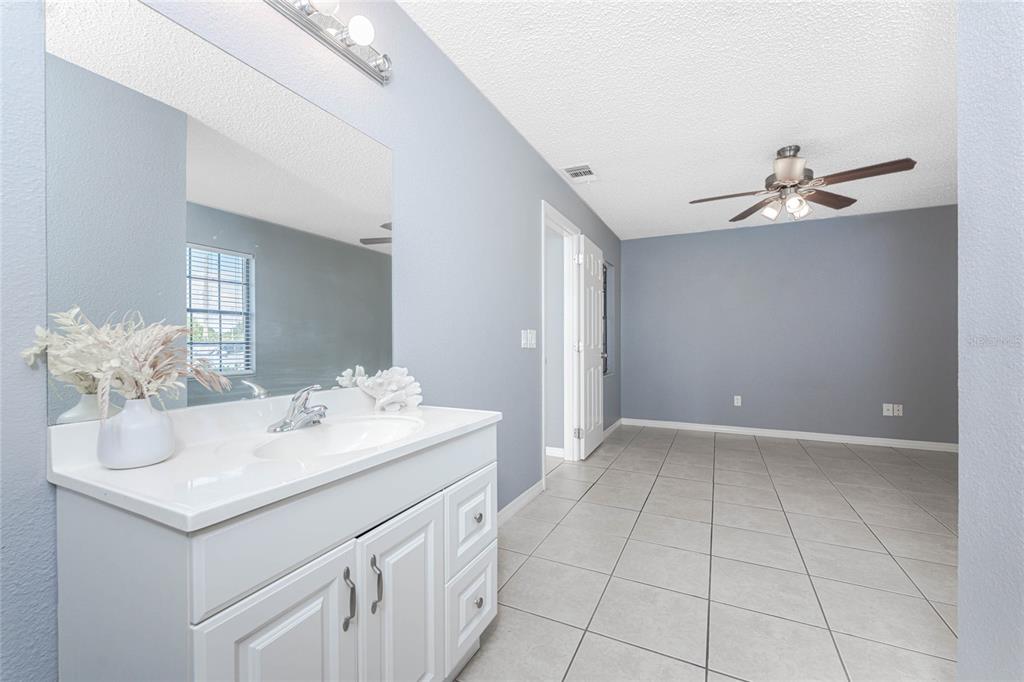 13100 South McCall Road, Unit 191 Port Charlotte, FL 33981 - Photo 23 of 44 a bathroom with a sink vanity and a mirror