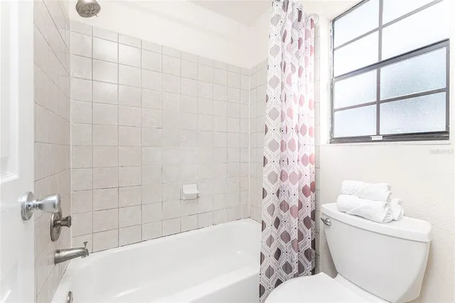 a bathroom with a toilet and a bathtub