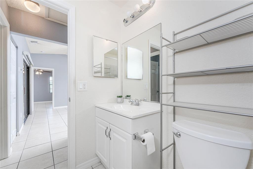 13100 South McCall Road, Unit 191 Port Charlotte, FL 33981 - Photo 29 of 44 a bathroom with a sink toilet vanity and shower