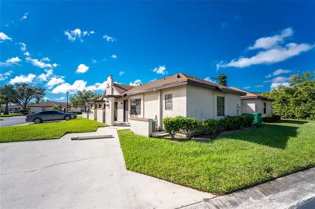 a view of a house with a yard and plants