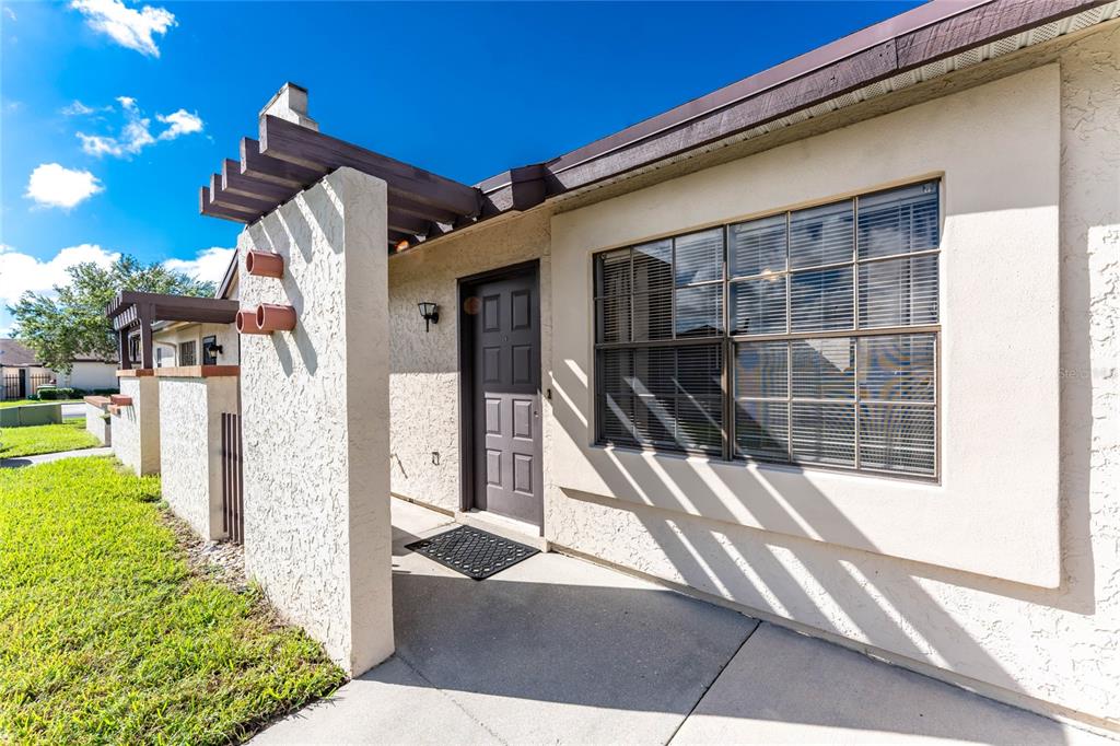 13100 South McCall Road, Unit 191 Port Charlotte, FL 33981 - Photo 7 of 44 a front view of a house with a yard