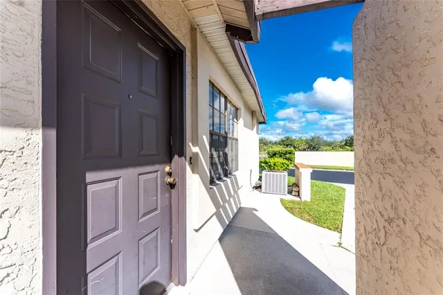 a view of a hallway with furniture and a fireplace